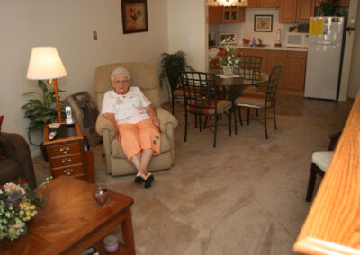 Woman in her 1 bedroom apartment with den at Lyon Township at Abbey Park
